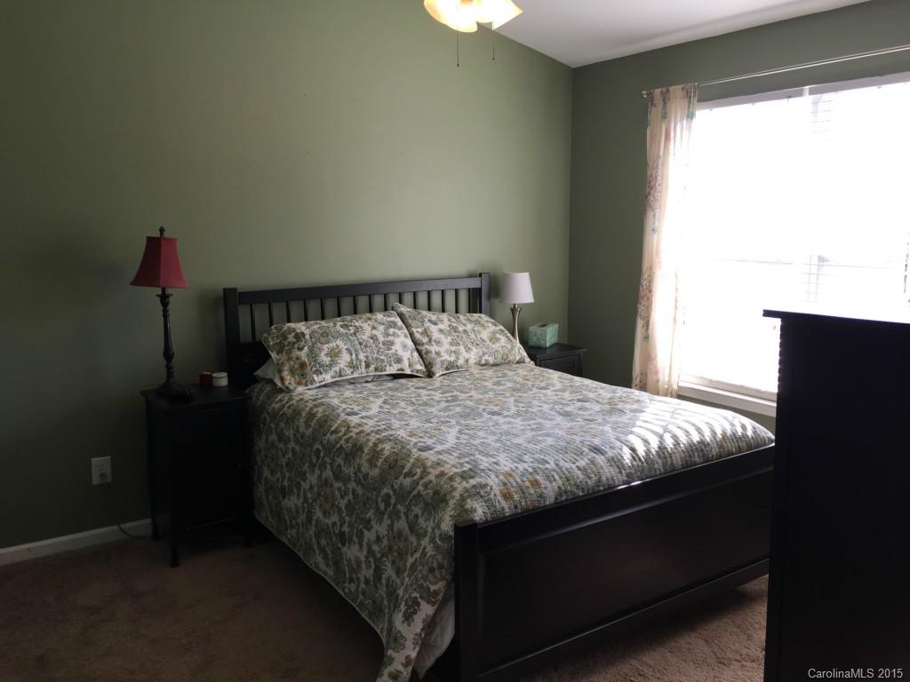 846 Gentlewinds Court, Unit 132 Fort Mill, SC 29708 - Photo 9 of 14 a bed sitting in a bedroom next to a window