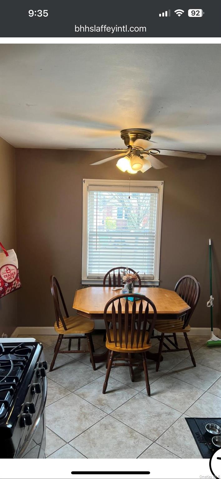 220 Raff Avenue Mineola, NY 11501 - Photo 5 of 22 Dining area featuring light tile patterned flooring and ceiling fan