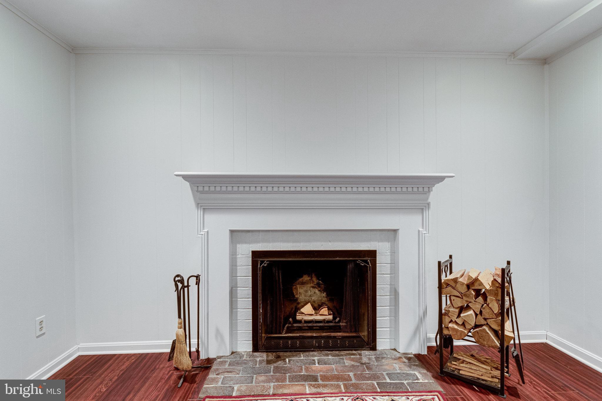 8434 Grenoble Court Springfield, VA 22152 - Photo 29 of 41 Wood burning fireplace in basement rec room