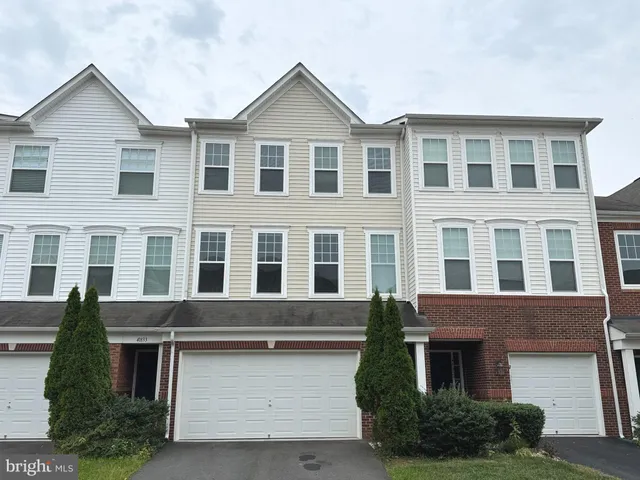 a front view of residential houses with yard
