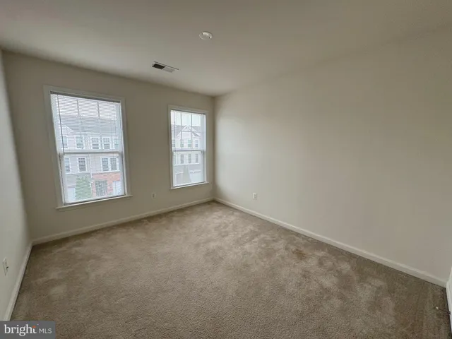 a view of an empty room and a window
