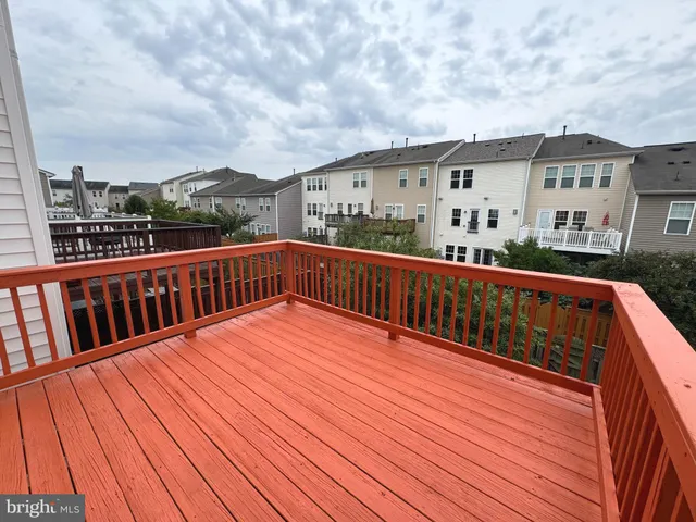 a view of balcony with wooden floor and fence