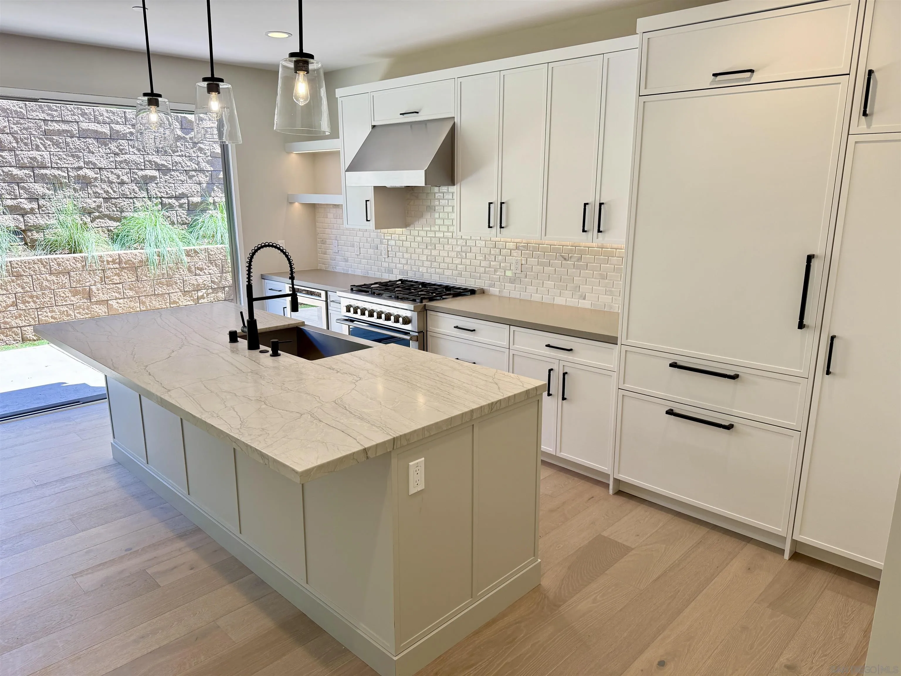 553 North Vulcan Avenue Encinitas, CA 92024 - Photo 6 of 21 a kitchen with white cabinets and white appliances