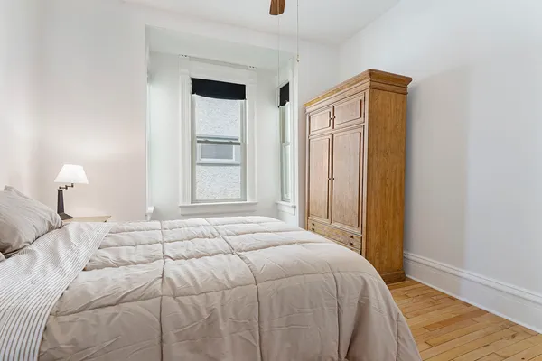 a bedroom with a bed and a window