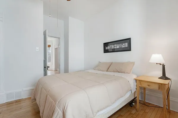 a bedroom with a bed and a lamp