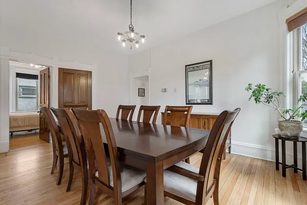 a view of a dining room with furniture and wooden floor