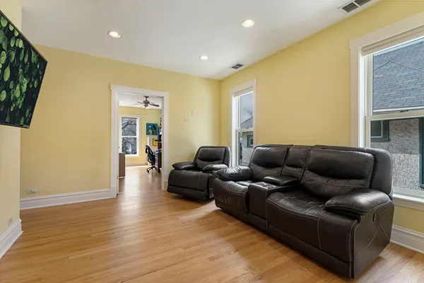 a living room with furniture and a wooden floor