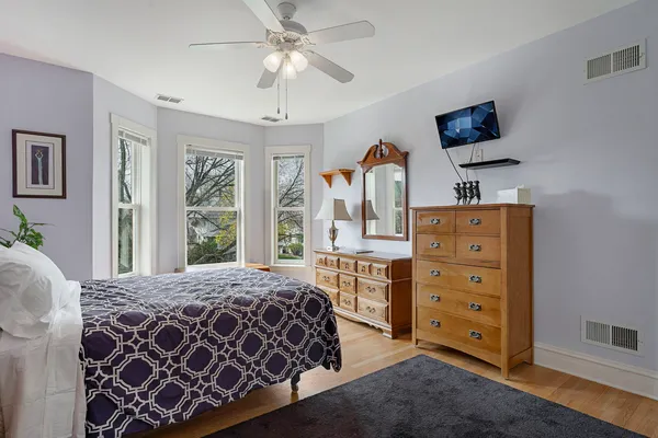 a bedroom with a bed and a dresser