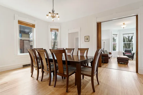 a view of a dining room with furniture and wooden floor
