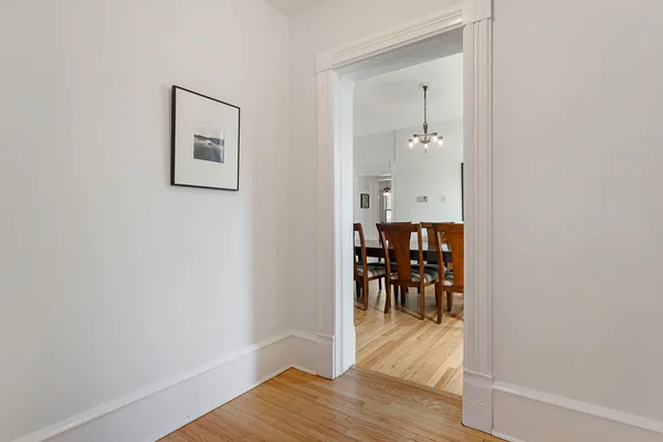 a view of a room with wooden floor kitchen view and dining room