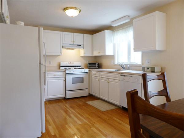 985 Trapelo Road, Unit 4 Waltham, MA 02452 - Photo 6 of 10 a kitchen with a sink a stove cabinets and wooden floor