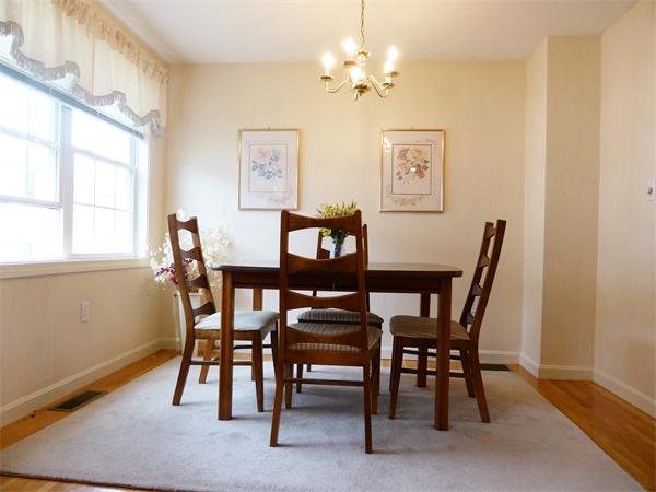 985 Trapelo Road, Unit 4 Waltham, MA 02452 - Photo 7 of 10 a view of a dining room with furniture and a window