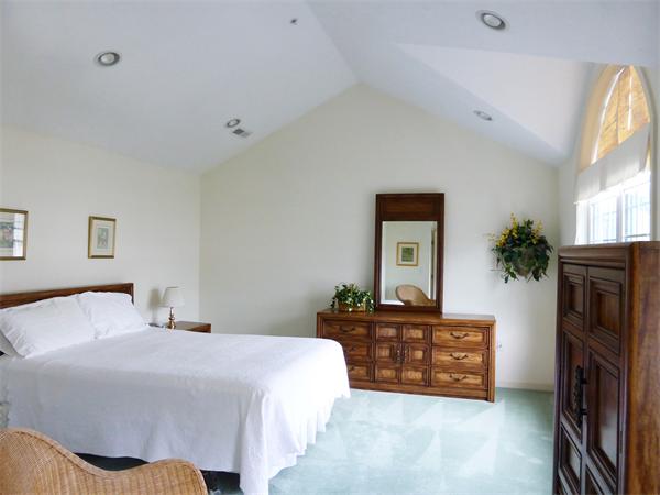 985 Trapelo Road, Unit 4 Waltham, MA 02452 - Photo 9 of 10 a bedroom with a bed and a television