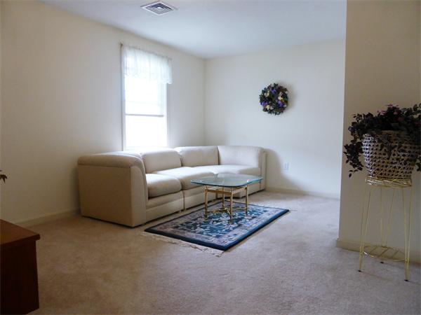 985 Trapelo Road, Unit 4 Waltham, MA 02452 - Photo 10 of 10 a living room with furniture and a window