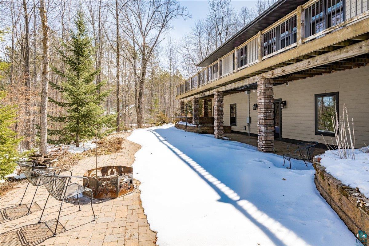 92598 Spells Road Sturgeon Lake, MN 55783 - Photo 50 of 60 Snow covered pool with a patio area, an outdoor fire pit, and a balcony