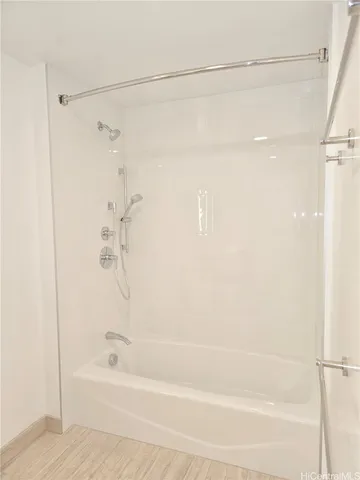 a bathroom with a shower and a bath tub