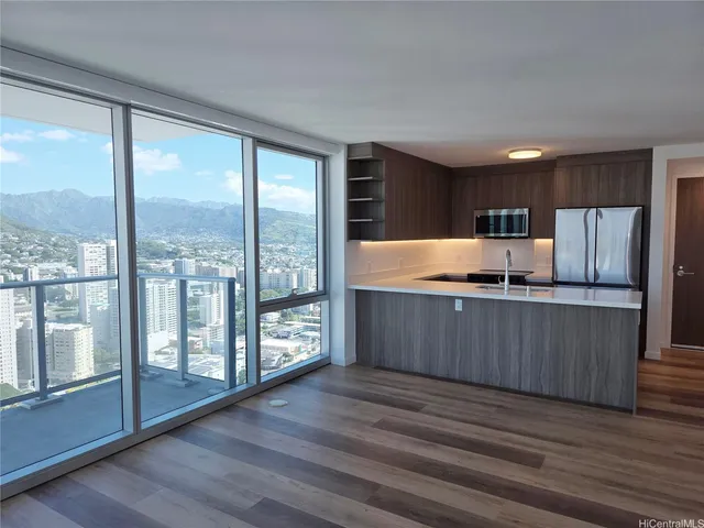 a kitchen with stainless steel appliances granite countertop a refrigerator a sink and wooden cabinets