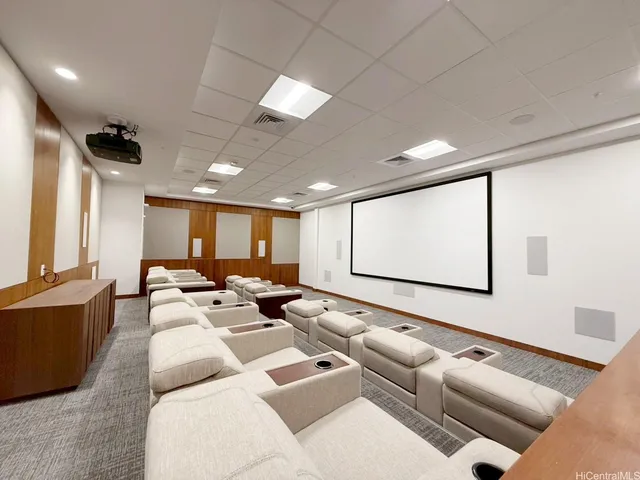 a media room with lots of furniture and a large window