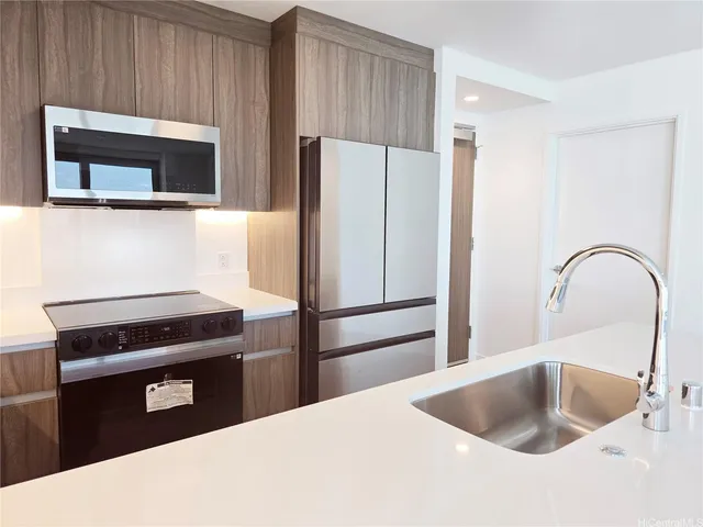 a kitchen with a refrigerator and a sink