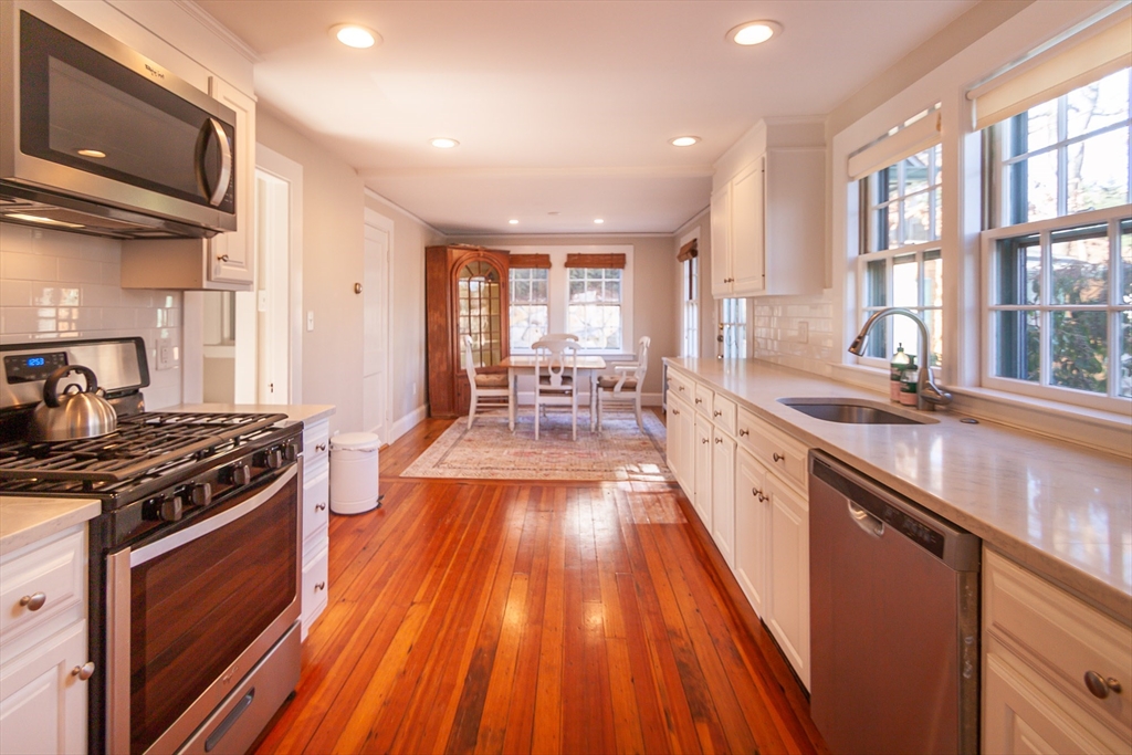 94 Atlantic Avenue, Unit 1 Cohasset, MA 02025 - Photo 11 of 23 a large kitchen with stainless steel appliances granite countertop a stove and a sink