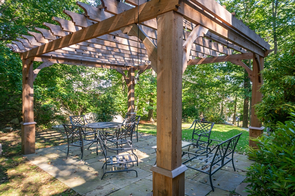 94 Atlantic Avenue, Unit 1 Cohasset, MA 02025 - Photo 13 of 23 a patio with table and chairs