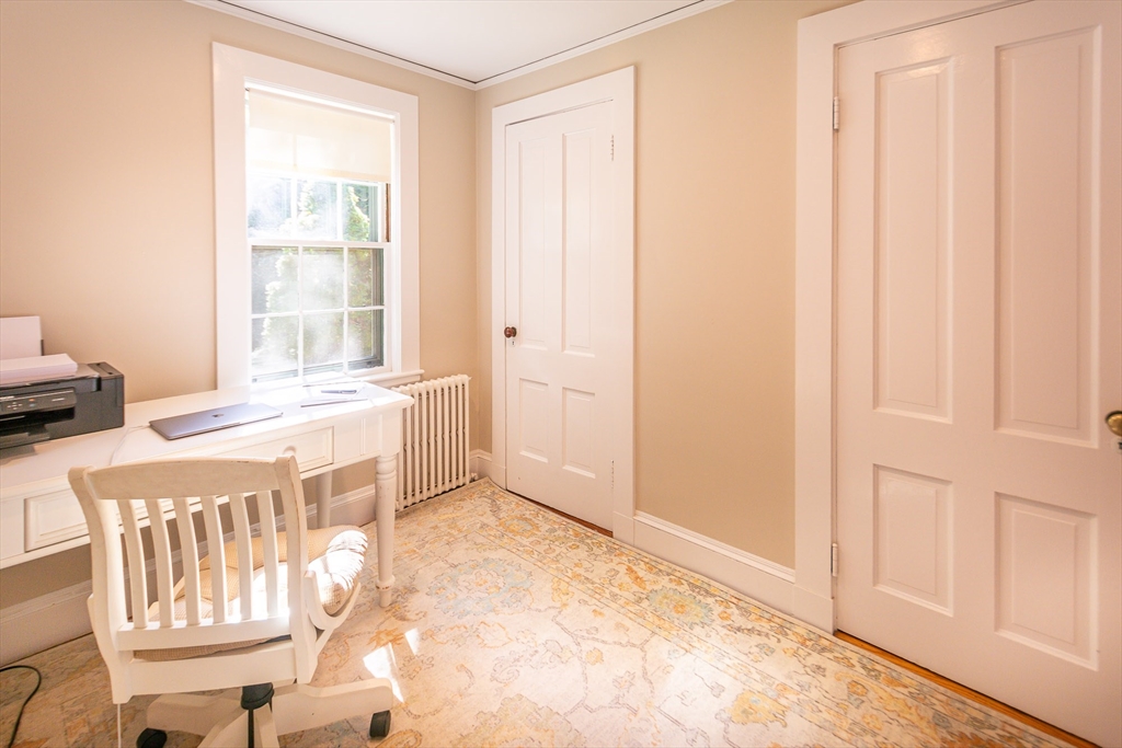94 Atlantic Avenue, Unit 1 Cohasset, MA 02025 - Photo 16 of 23 a spacious bedroom with a bed and a window