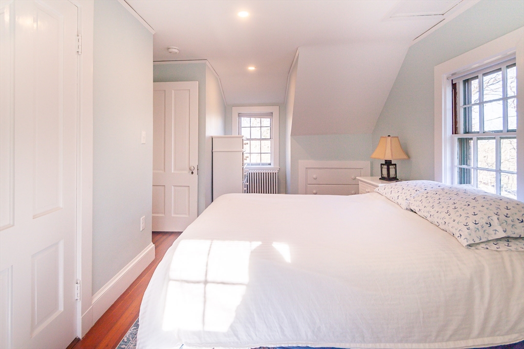 94 Atlantic Avenue, Unit 1 Cohasset, MA 02025 - Photo 19 of 23 a bedroom with a bed and a window