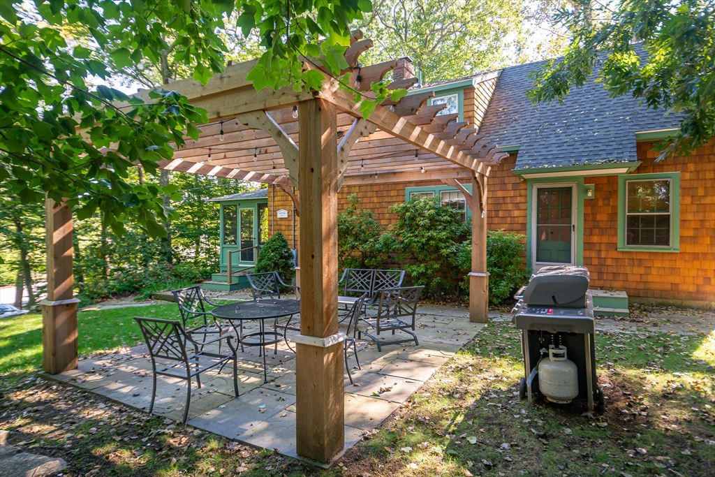 94 Atlantic Avenue, Unit 1 Cohasset, MA 02025 - Photo 2 of 23 a garden view with a seating space