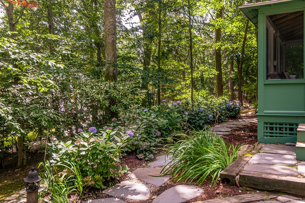94 Atlantic Avenue, Unit 1 Cohasset, MA 02025 - Photo 22 of 23 a backyard of a house with lots of green space