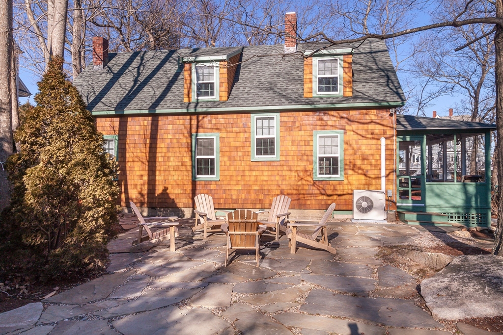 94 Atlantic Avenue, Unit 1 Cohasset, MA 02025 - Photo 3 of 23 a view of a patio with table and chairs and potted plants