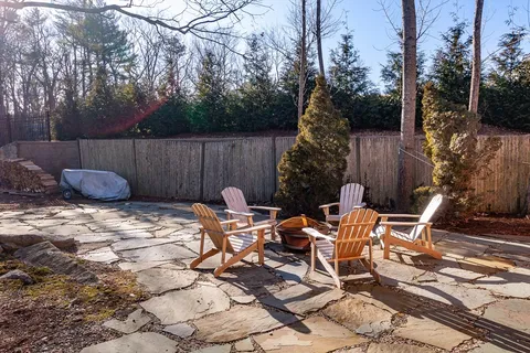 a backyard of a house with table and chairs