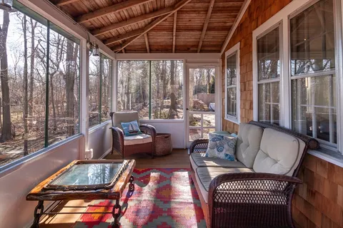a living room with furniture and a floor to ceiling window