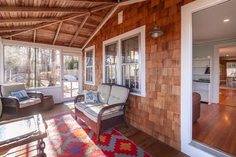 a living room with furniture and a floor to ceiling window