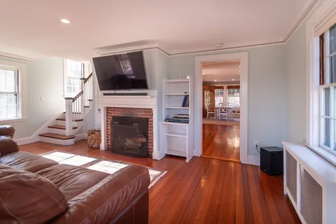 a living room with furniture fireplace and flat screen tv
