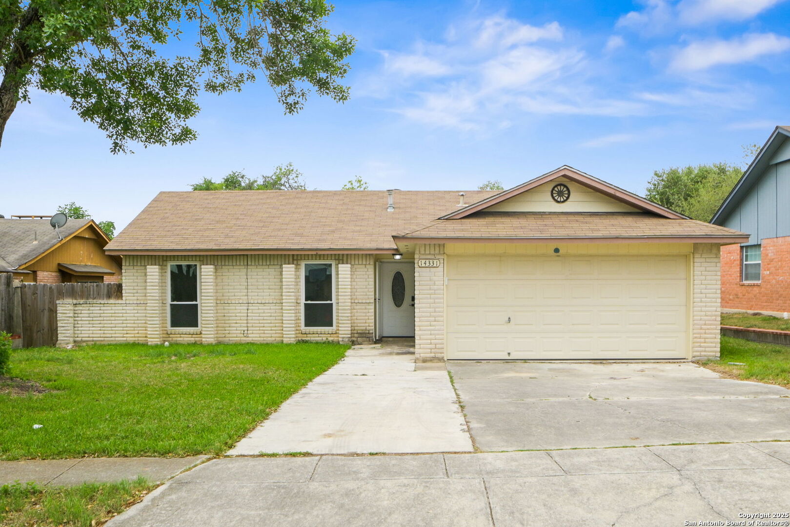 a front view of a house with a garden and yard