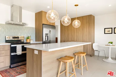 a kitchen with a table and chairs in it