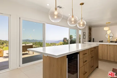 a room with a large window and a view of living room