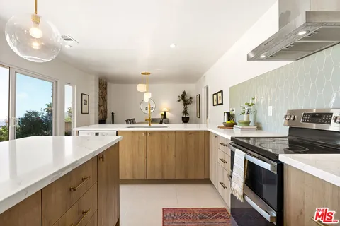 a kitchen with stainless steel appliances granite countertop a sink and stove