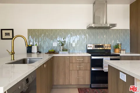 a kitchen with granite countertop a stove and a sink