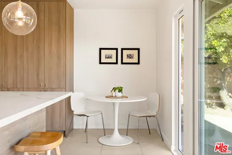 a dining room with furniture and a window