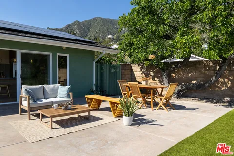 a view of a patio with a table and chairs