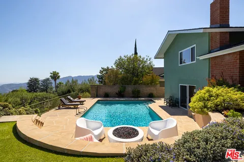 a view of a swimming pool with a patio