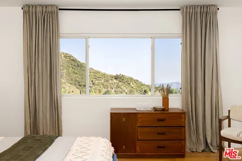a view of bedroom with a bed and a window