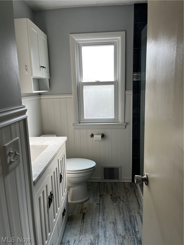 30824 Clarmont Road Willowick, OH 44095 - Photo 18 of 24 Bathroom with hardwood / wood-style floors, vanity, and toilet