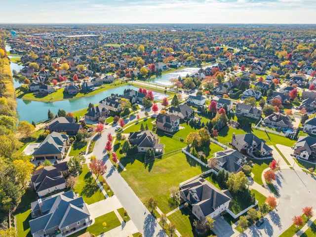 an aerial view of a house with a garden and swimming pool