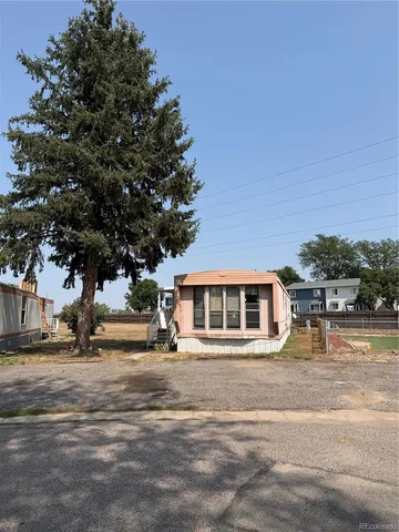 a front view of a building with trees