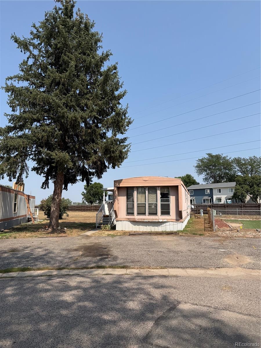 a front view of a building with trees