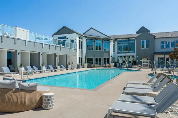 a front view of a house with swimming pool table and chairs