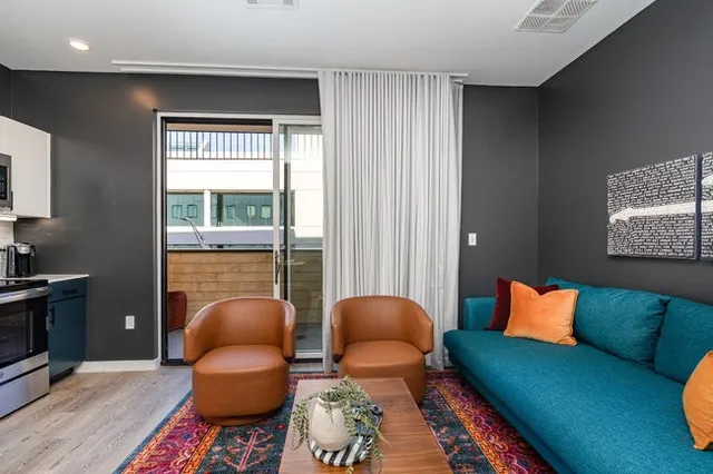 a bedroom with a bed and a refrigerator