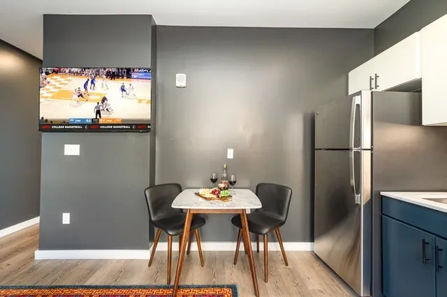 a kitchen with granite countertop a refrigerator and a sink